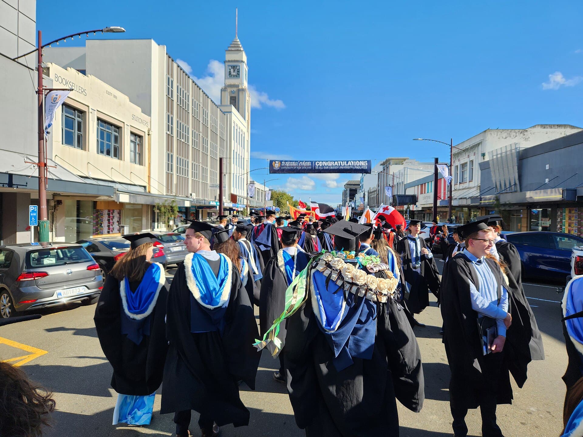 International graduates in gowns walking in a university graduation procession