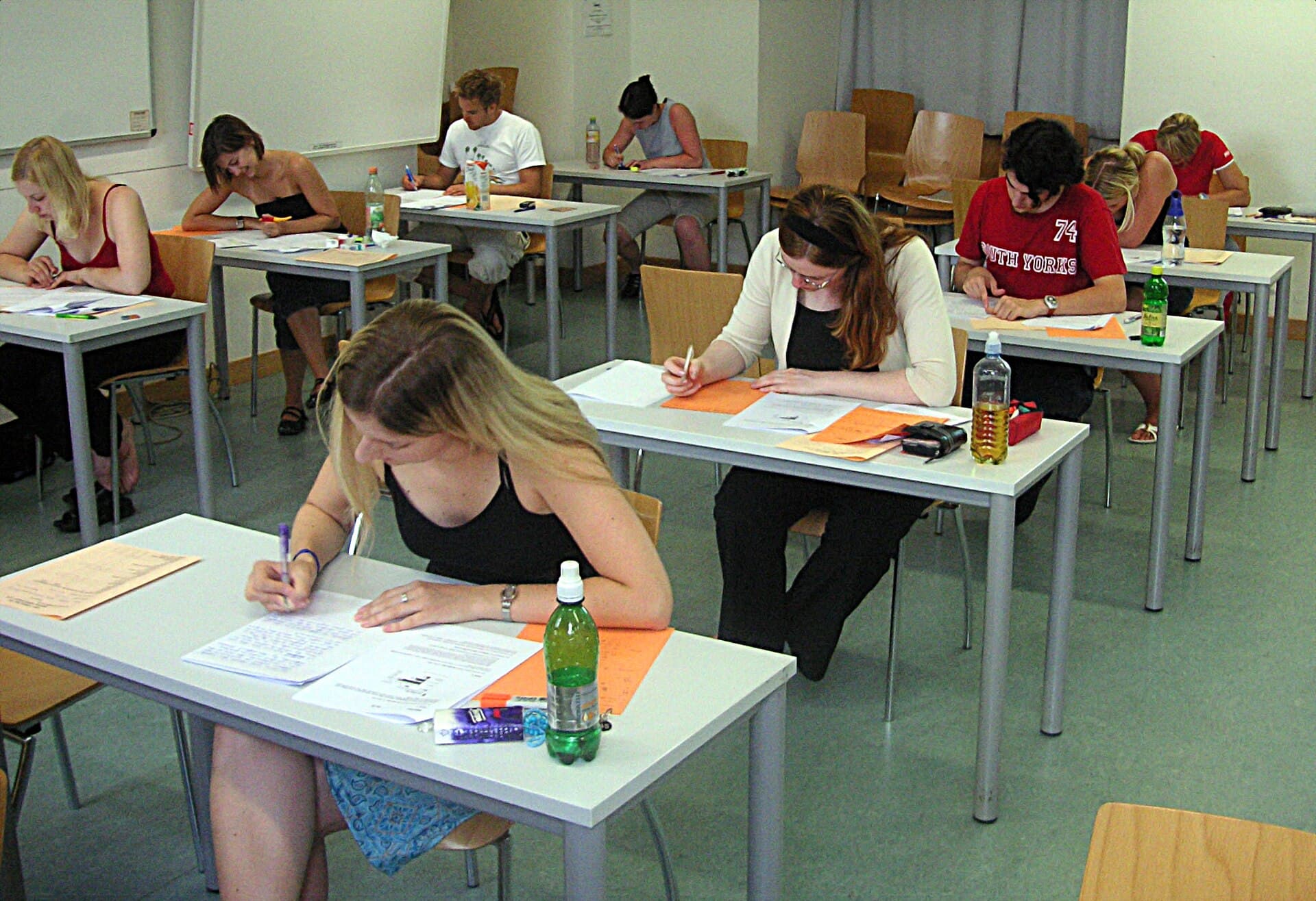 Students sitting a written examination at individual desks in a classroom