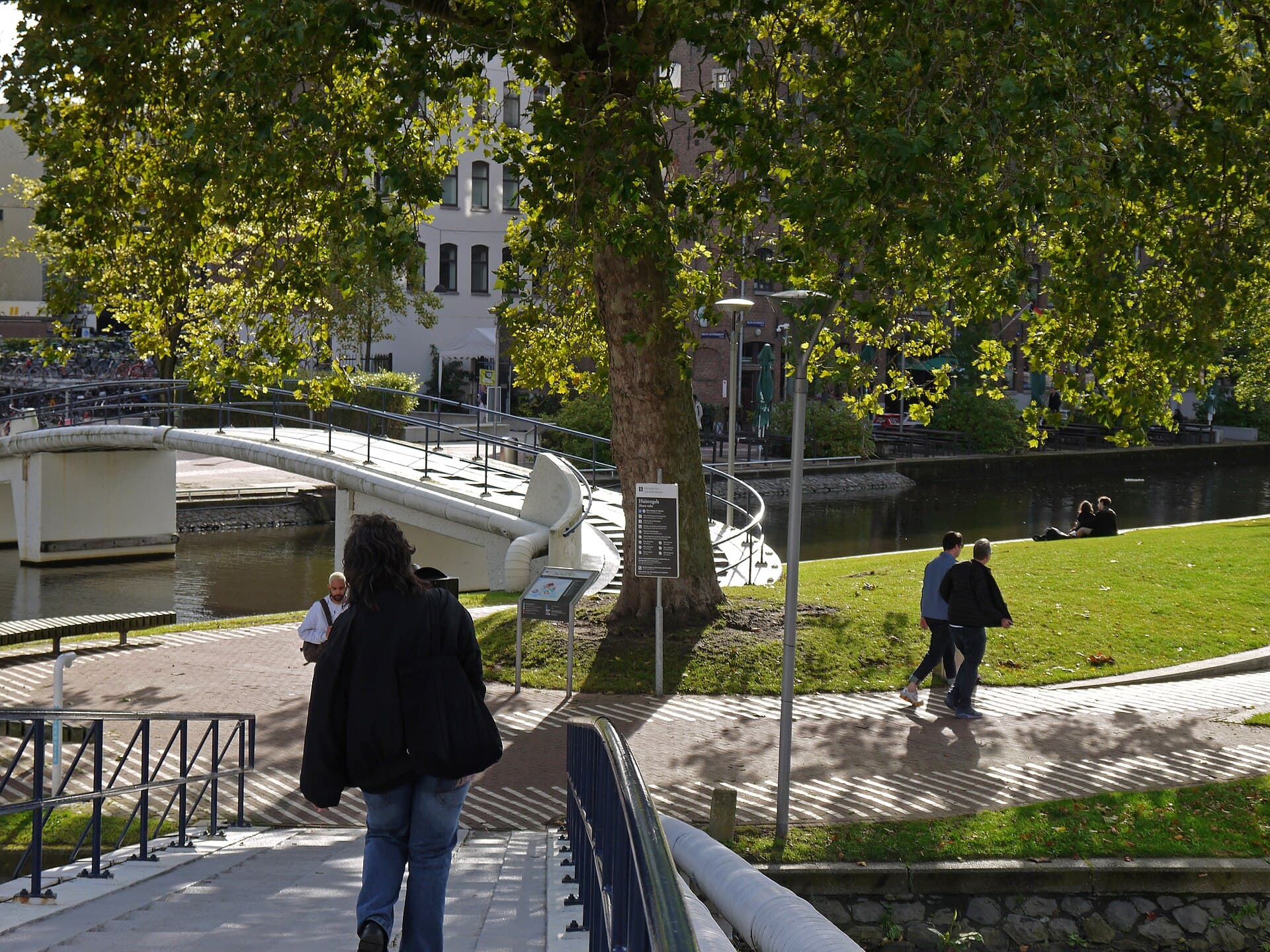 Students walking across a university campus on an autumn afternoon