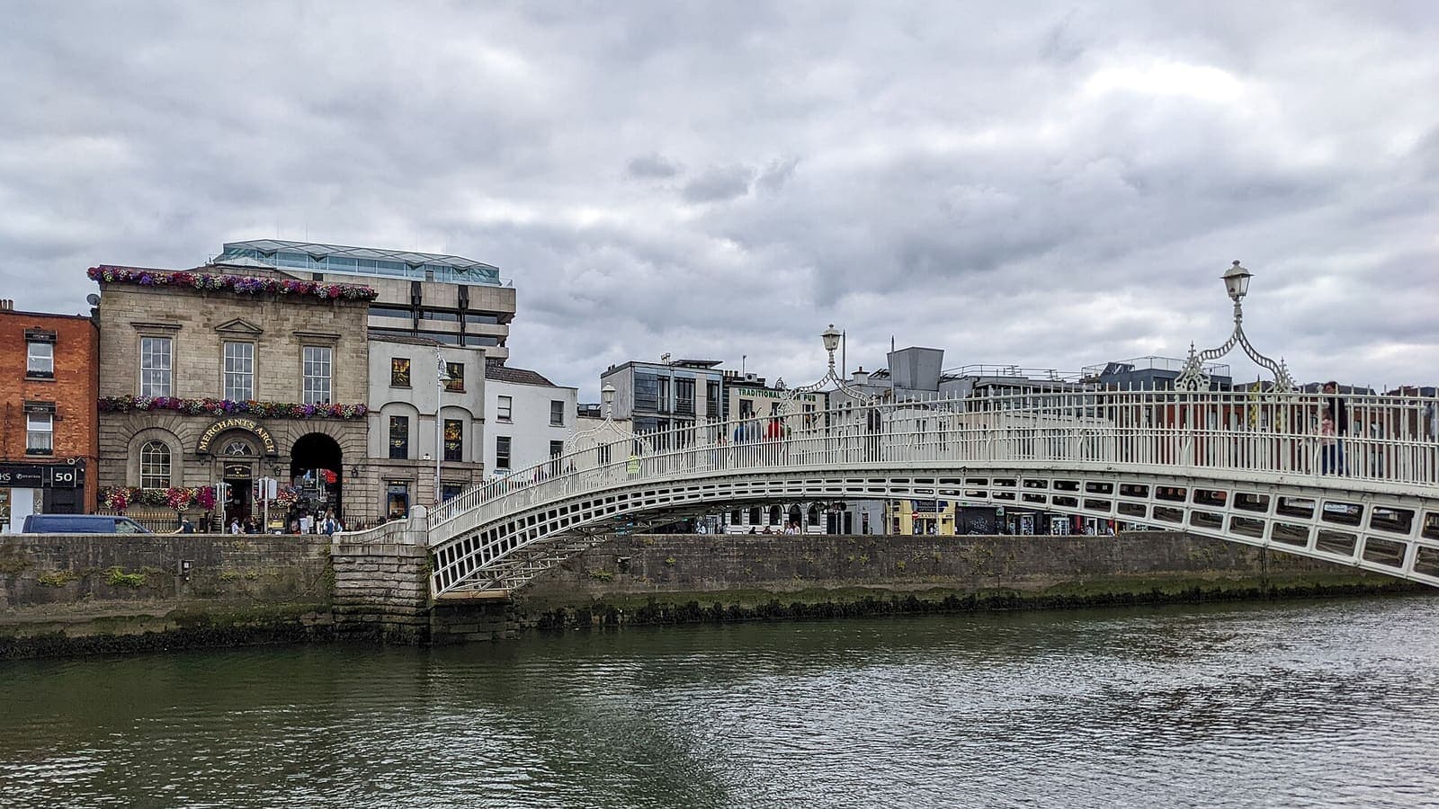 The white cast-iron Ha'penny Bridge over the River Liffey in Dublin city centre