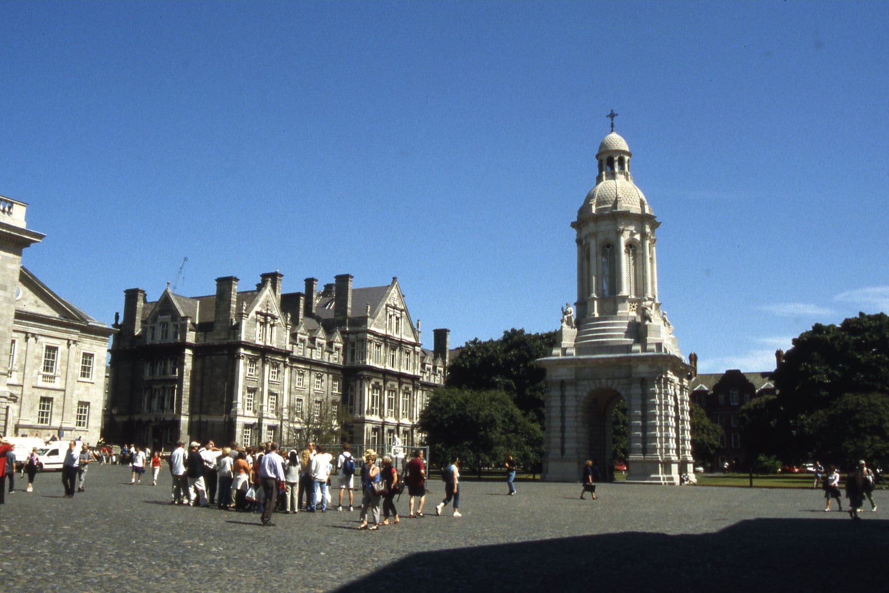 Parliament Square at Trinity College Dublin, with the campanile and students crossing the cobbles